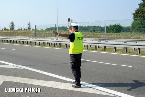 Policjant zatrzymuje pojazd do kontroli drogowej.