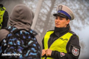 Policjantka rozdaje odblaski.