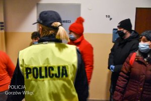 policjantka i inne osoby na klatce schodowej